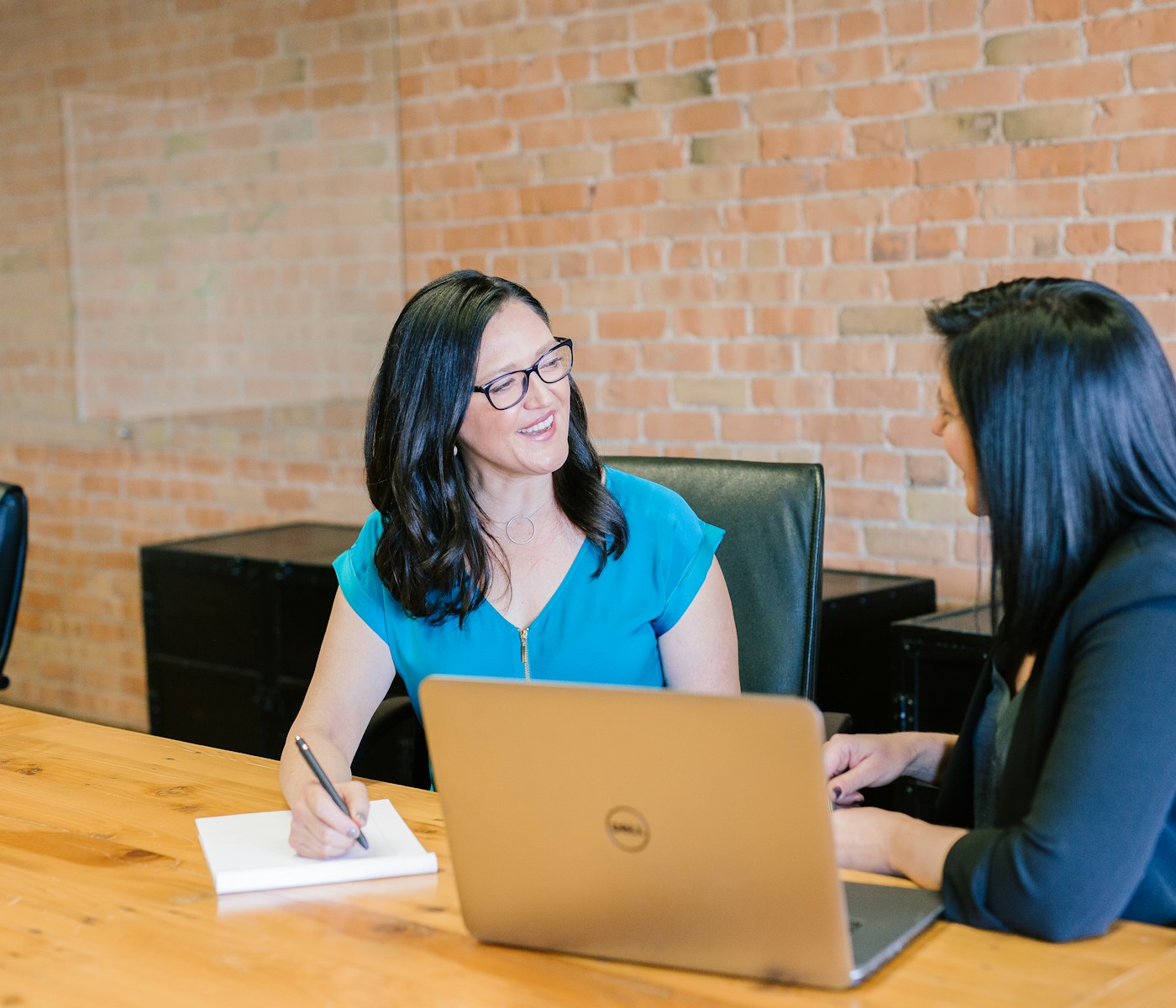 Two professionals having a thoughtful conversation in an office